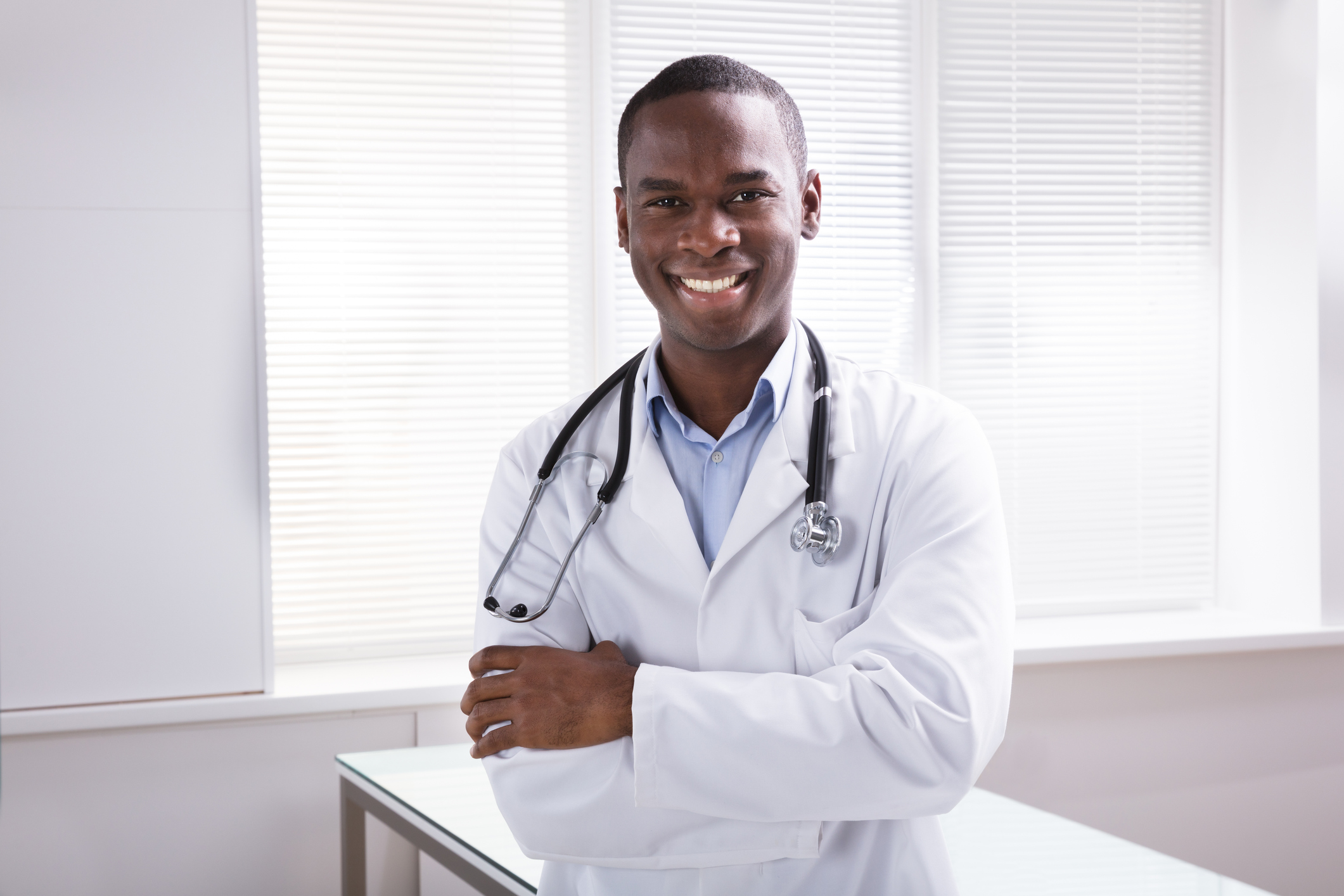 Чернокожий доктор. Чернокожий врач. Врач афроамериканец. Негр медик. Врач улыбается.